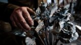 Viktor Mikhalev turned weapons and ammunitions to roses at a workshop in his house in Donetsk, Russian-controlled Donetsk area. (AP Photo/Alexei Alexandrov)