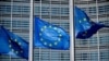 FILE PHOTO: European Union flags fly outside the European Commission headquarters in Brussels