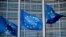 FILE PHOTO: European Union flags fly outside the European Commission headquarters in Brussels