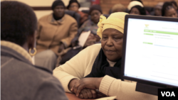 Emilia Khoza, evicted from her house when she was eight years old, at the Pretoria Land Claims office, Pretoria, South Africa. (Gillian Parker/VOA)