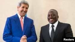 President of the Democratic Republic of Congo (DRC) Joseph Kabila (R) welcomes U.S. Secretary of State John Kerry at the Palais de la Nation in Kinshasa May 4, 2014. 