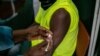 A Zimbabwean receives a COVID-19 vaccine jab at Wilkins Hospital - Zimbabwe’s main vaccination center in Harare on May 12, 2021 when things were still on course. Then shortages began. (Columbus Mavhunga/VOA)