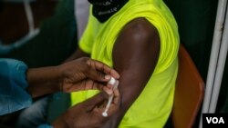 A Zimbabwean receives a COVID-19 vaccine jab at Wilkins Hospital - Zimbabwe’s main vaccination center in Harare on May 12, 2021 when things were still on course. Then shortages began. (Columbus Mavhunga/VOA)