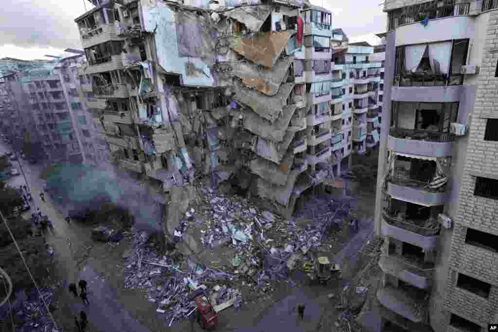 Bulldozers remove the rubble of a destroyed building that was hit Sunday night by an Israeli airstrike in Dahiyeh, in the southern suburb of Beirut, Lebanon.