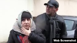 FILE - Azerbaijani rights activist Leyla Yunus walks with her husband Arif Yunus after she was released from prison in Baku, Azerbaijan, Dec. 9, 2015.