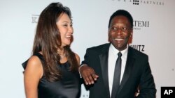 FILE - Brazilian soccer great Pele and businesswoman Marcia Cibele Aoki pose on the red carpet of The Foundation for AIDS Research event in Sao Paulo, Brazil, April 5 2013. 