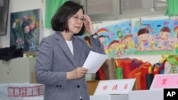 Taiwanese President Tsai Ing-wen waits to cast her ballot at a polling station, Saturday, Nov. 24, 2018, in Taipei, Taiwan. 