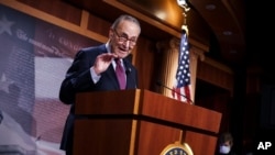 Senate Majority Leader Chuck Schumer, D-N.Y., praises his Democratic Caucus at a news conference just after the Senate narrowly approved a $1.9 trillion COVID-19 relief bill, at the Capitol in Washington, March 6, 2021. 