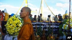 Earlier today, in Cambodia, a group of monks and officials pray for victims near the site where people stampeded during Monday's water festival in Phnom Penh.