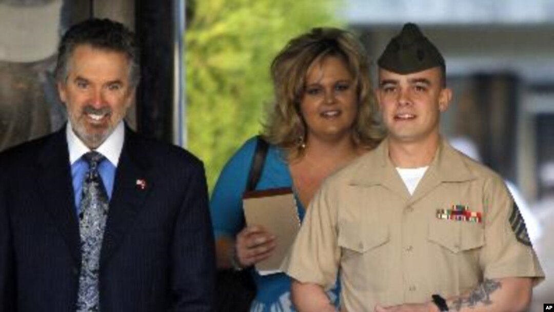 Marine Corps Sgt. Frank D. Wuterich arrives for a pre-trial hearing with his lawyer Neal A. Puckett and girlfriend Melissa Balcombe at Camp Pendleton, California March 22, 2010.