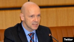 FILE - Thomas Hushek delivers remarks at a briefing in Vienna, Austria, Sept. 15, 2014. (Twitter - @usunvie)