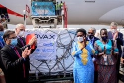 FILE - Uganda's Minister of Health Dr. Jane Ruth Aceng and other officials greet the country's first consignment of AstraZeneca COVID-19 vaccine provided through the global COVAX initiative, at the airport in Entebbe, March 5, 2021.
