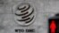 FILE - A logo is pictured outside the World Trade Organization headquarters next to a red pedestrian traffic light, in Geneva, Switzerland, Oct. 2, 2018.
