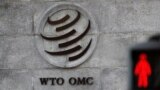 FILE - A logo is pictured outside the World Trade Organization (WTO) headquarters next to a red pedestrian traffic light, in Geneva, Switzerland, Oct. 2, 2018.