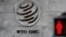 FILE - A logo is pictured outside the World Trade Organization (WTO) headquarters next to a red pedestrian traffic light, in Geneva, Switzerland, Oct. 2, 2018.