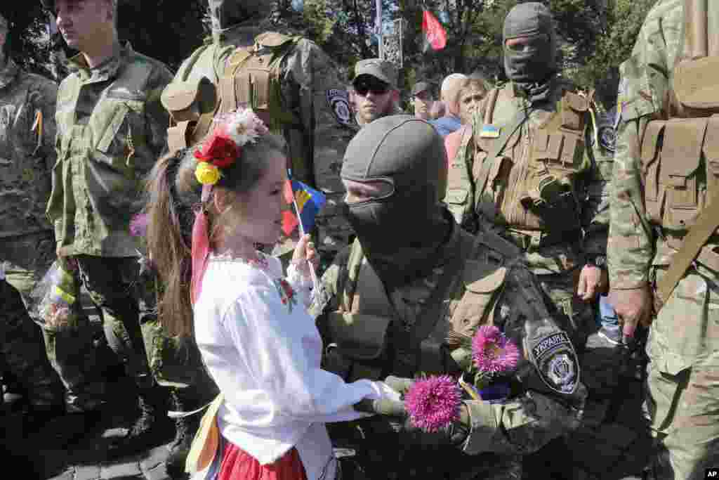Relatives and friends say good-bye to volunteers before they were sent to the eastern part of Ukraine to join the ranks of a special battalion unit fighting against pro-Russian separatists, in Kyiv, Ukraine, Aug. 26, 2014.