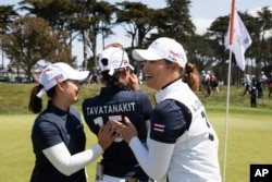 Thailand's Moriya Jutanugarn, left, Patty Tavatanakit, center, and Ariya Jutanugarn celebrate a semifinal victory over The United States at the International Crown match play golf tournament in San Francisco, Sunday, May 7, 2023.