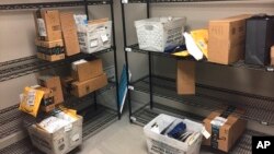 FILE - Packages from Internet retailers are delivered with the U.S. Mail in a apartment building mail room in Washington, April 13, 2018.