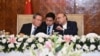 Pakistani President Asif Ali Zardari, right, and Chinese Premier Li Qiang, left, interact during a state luncheon in Islamabad, Pakistan, on Oct. 15, 2024. (Pakistan's Press Information Department via Reuters)