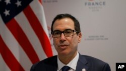 FILE - U.S. Treasury Secretary Steve Mnuchin answers reporters after the G-7 Finance, July 18, 2019 in Chantilly, north of Paris, France.