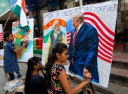 Children from an art school make paintings of U.S. President Donald Trump ahead of his India visit, in Mumbai, India, Feb. 21, 2020.