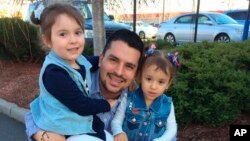 In this undated family photo provided by Sandra Chica, Pablo Villavicencio poses with his two daughters, Luciana, left, and Antonia.