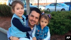 In this undated family photo provided by Sandra Chica, Pablo Villavicencio poses with his two daughters, Luciana, left, and Antonia.