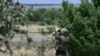 Украинский военнослужащий зенитного подразделения 24-й механизированной бригады осматривает небо на предмет российских беспилотников и самолетов на позиции в Донецкой области, 11 июня 2024 года.