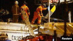 Rescue workers examine the wreckage of police helicopter that crashed on roof of the Clutha Vaults pub, Glasgow, Scotland, Nov. 30, 2013.