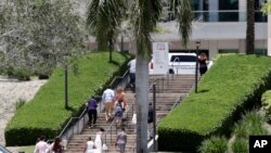 People arrive for a graduation ceremony for Marjory Stoneman Douglas High School seniors, June 3, 2018, in Sunrise, Florida. 