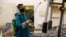 An employee from a disinfection service company wears a protective mask while sanitizing sports equipment at the gym of Benghazi Medical Center, following the outbreak of the coronavirus disease (COVID-19), in Benghazi, Libya, Aug. 6, 2020. 