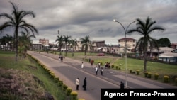 FILE - People walk by the entrance of the University of Buea, South-West Region of Cameroon, on April 27, 2018.