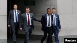  Actor Cuba Gooding Jr. is escorted handcuffed by NYPD officers as he exits the New York City Police Department's (NYPD) Special Victims Division (SVU) in the Harlem neighborhood of New York, June 13, 2019.