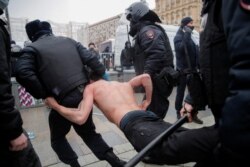 Riot police detain a protester during January 23, 2021, rally for Navalny.