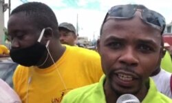 Renèl Pierre, president of the National Union of Haitian Money Exchange Agents, speaks during a protest in Port au Prince, Haiti. (Matiado Vilme/VOA)