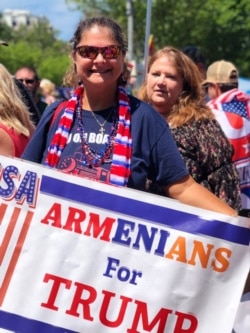 Caroline Sarajian shows off her “Armenians for Trump” banner, July 4, 2019, on the National Mall in Washington.