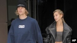 FILE - Justin Bieber and Hailey Baldwin are seen in New York City, Sept. 14, 2018. Bieber and Bailey announced they got married in September on Instagram. 