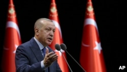 Turkey's President Recep Tayyip Erdogan speaks during a meeting in Ankara, Turkey, Feb. 11, 2020. Erdogan on Tuesday warned the Syrian government that it will "pay a very, very heavy price" for attacks on Turkish troops. 