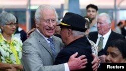 Britain's King Charles embraces Uncle James 'Michael' Widdy Welsh, a member of the Indigenous community, during a visit to the National Centre of Indigenous Excellence in Sydney, Australia, October 22, 2024.