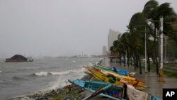 Small fishing boats are placed by the seawall as strong winds and slight rain brought by Typhoon Koppu hit Manila, Philippines, Oct. 18, 2015.