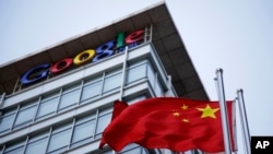 FILE - The Chinese flag is seen near Google signage at the Google China headquarters in Beijing.