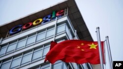 FILE - The Chinese flag is seen near the Google sign at the Google china headquarters in Beijing, China.