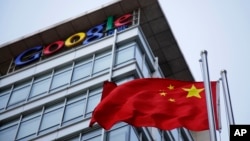 FILE - The Chinese flag is seen near the Google sign at the Google china headquarters in Beijing, China.