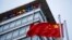 FILE - The Chinese flag is seen near the Google sign at the Google china headquarters in Beijing, China.