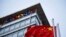 FILE - The Chinese flag is seen near the Google sign at the Google china headquarters in Beijing, China.