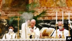 Pope Francis celebrates the Easter vigil in a nearly empty St. Peter's Basilica as coronavirus pandemic restrictions stay in place for a second year running, at the Vatican, April 3, 2021. 