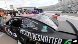 FILE - The car for driver Bubba Wallace has a Black Lives Matter logo as it is prepared for a NASCAR Cup Series auto race in Martinsville, Va., June 10, 2020.