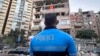 A Lebanese police officer looks at damaged apartments that were hit by Israeli strike early Sept. 30, 2024. 