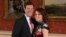 FILE - Britain's Princess Eugenie and Jack Brooksbank pose for the media in the Picture Gallery at Buckingham Palace after they announced their engagement in London, Jan. 22, 2018.
