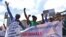 FILE - Environmental activists chant slogans as they carry placards and banners during a protest in Nairobi, Kenya, March 1, 2018, against a government decision to construct a standard-gauge railway line across the Nairobi National Park. 